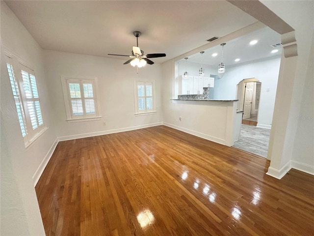 3025 W N A St, Tampa, FL 33609 - unfurnished living room with wood finished floors, arched walkways, visible vents, and ceiling fan