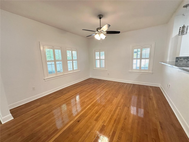 3025 W N A St, Tampa, FL 33609 - unfurnished living room with baseboards, ceiling fan, and wood finished floors