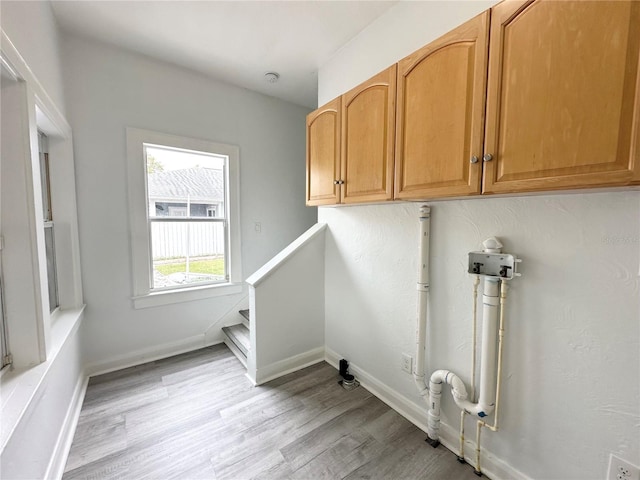 3025 W N A St, Tampa, FL 33609 - laundry area with light wood finished floors, cabinet space, and baseboards