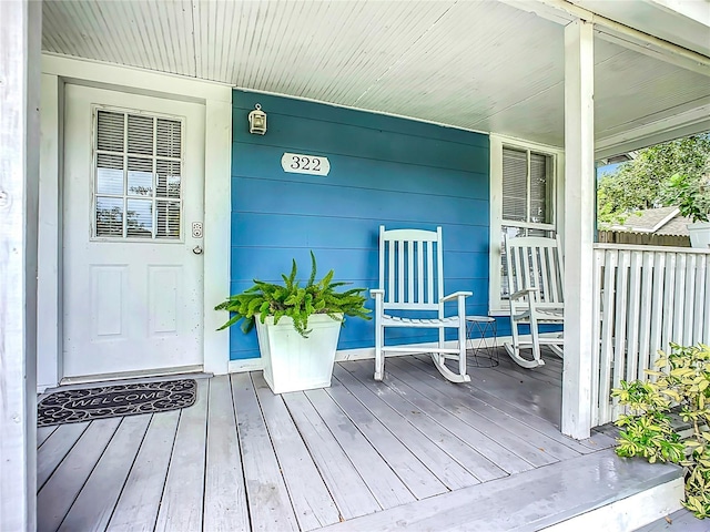 view of exterior entry with covered porch