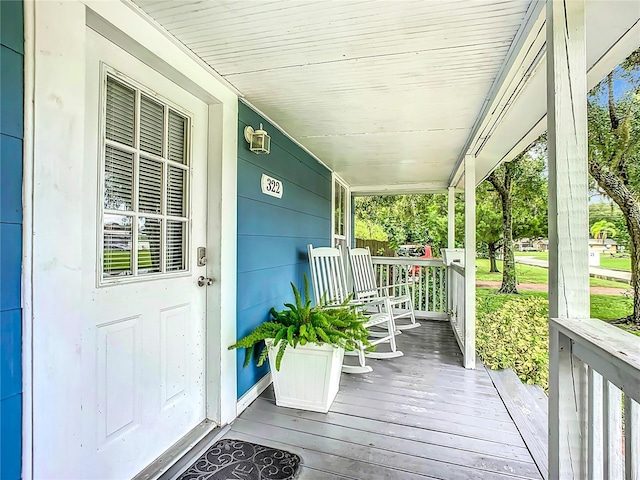 wooden terrace featuring covered porch