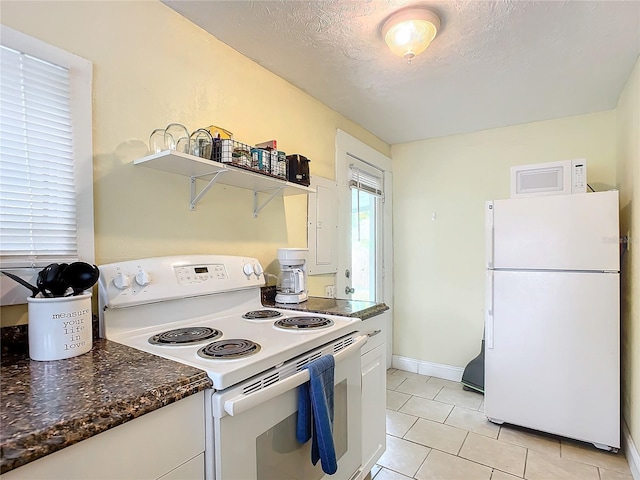 kitchen featuring a textured ceiling, light tile patterned flooring, white appliances, white cabinets, and open shelves