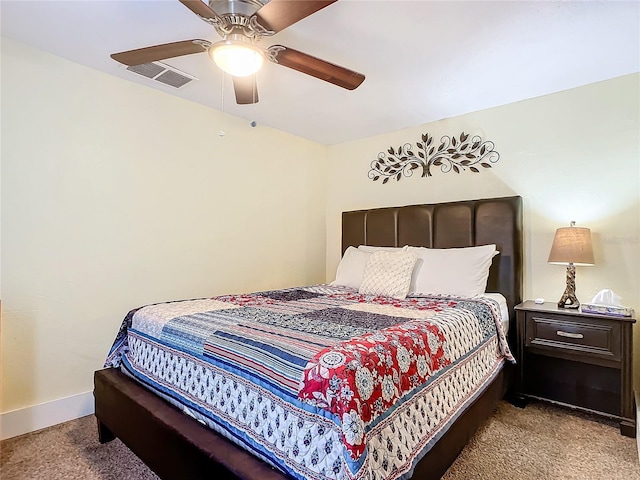 carpeted bedroom with baseboards, visible vents, and ceiling fan