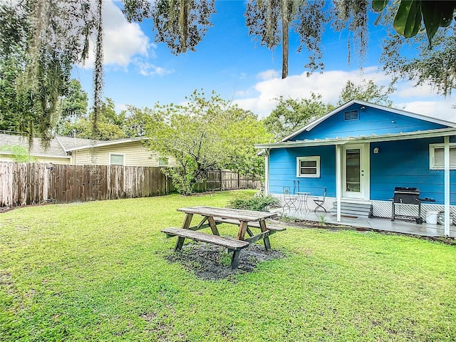 view of yard featuring a porch and fence