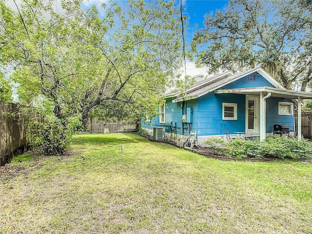 view of yard featuring a fenced backyard and central air condition unit