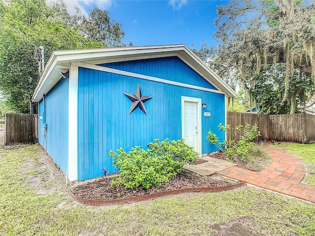 view of outbuilding with fence