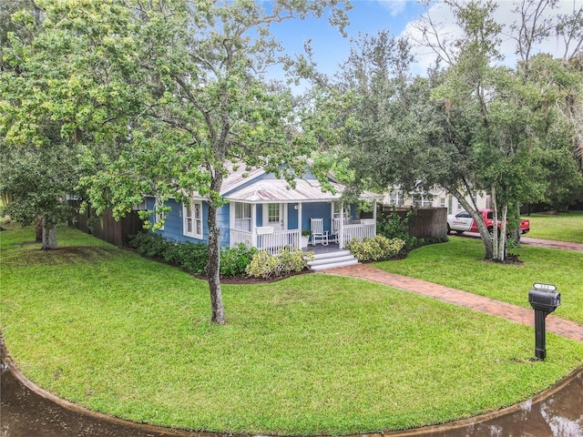 view of front of home with covered porch and a front yard