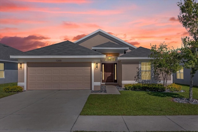 ranch-style home with a front lawn, driveway, an attached garage, and stucco siding