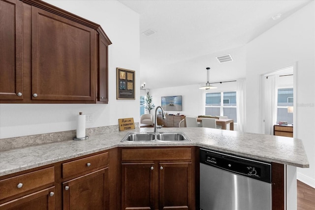 kitchen featuring visible vents, dishwasher, a peninsula, light countertops, and a sink