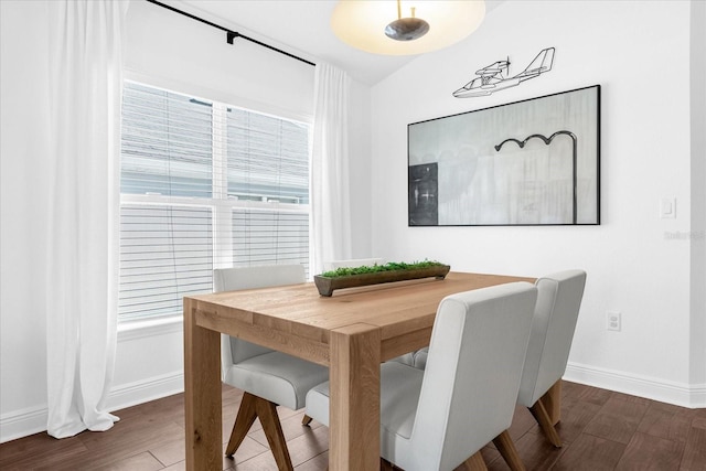 dining room featuring baseboards and wood finished floors