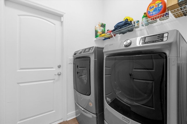 clothes washing area with laundry area and washer and clothes dryer