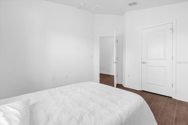 bedroom with visible vents and wood finished floors