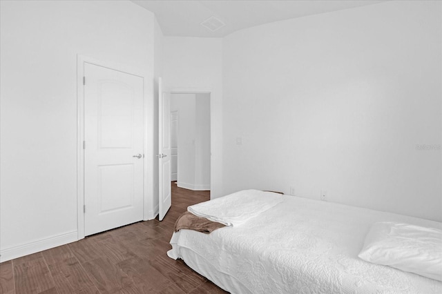 bedroom featuring wood finished floors and baseboards