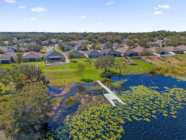 birds eye view of property with a water view and a residential view