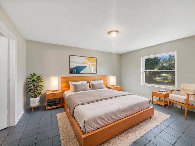 bedroom with dark tile patterned flooring