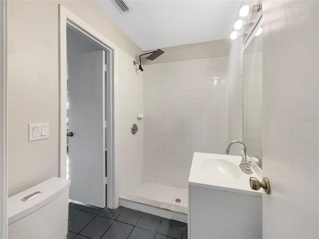 full bathroom featuring visible vents, toilet, a shower stall, vanity, and tile patterned flooring