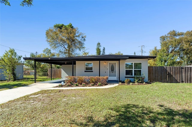 view of front of property with an attached carport, concrete driveway, fence, and a front lawn