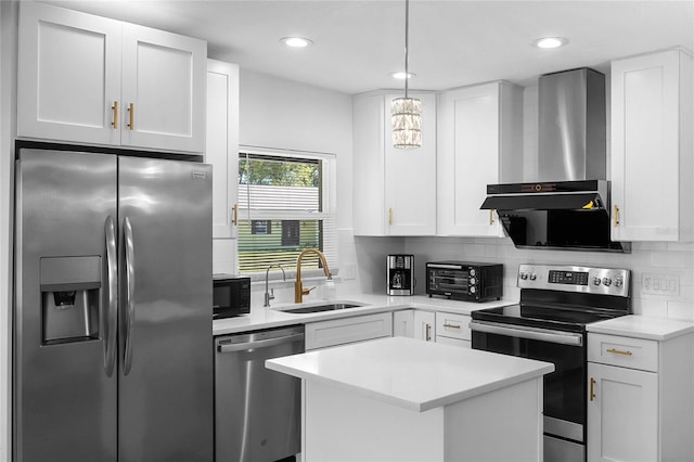 kitchen with a sink, white cabinets, appliances with stainless steel finishes, backsplash, and wall chimney exhaust hood