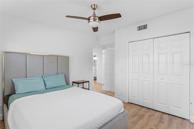 bedroom featuring a ceiling fan, a closet, visible vents, and light wood-style floors