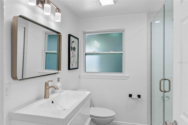 bathroom with baseboards, vanity, toilet, and an enclosed shower