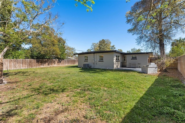 back of property featuring a patio area, a fenced backyard, cooling unit, and a yard