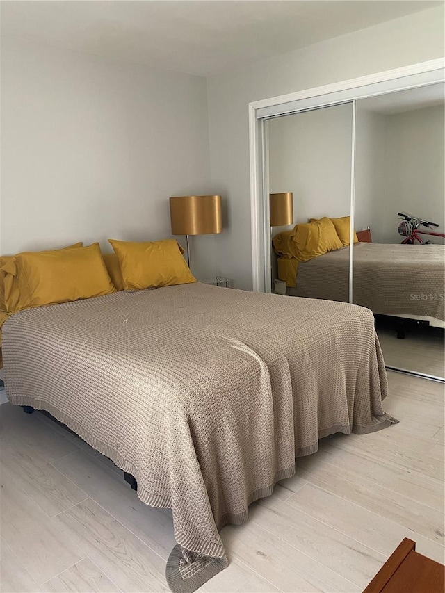 bedroom featuring a closet and wood finished floors