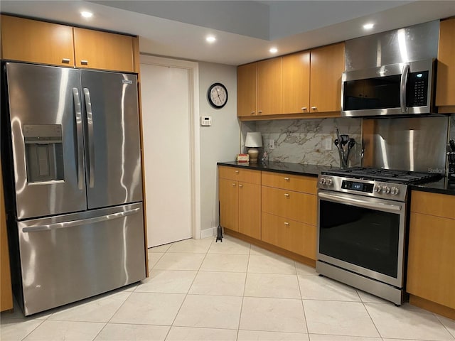 kitchen featuring appliances with stainless steel finishes, light tile patterned flooring, backsplash, and recessed lighting