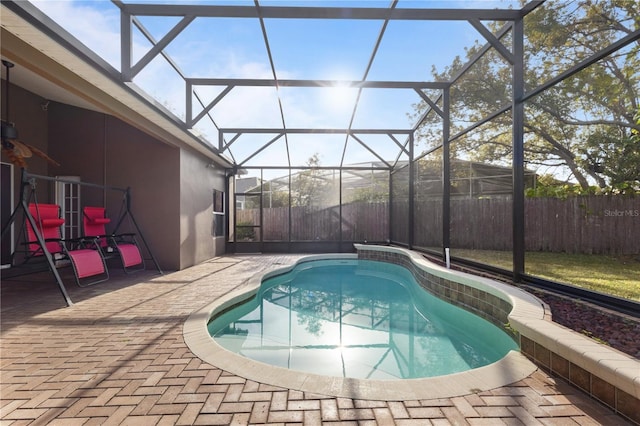 view of swimming pool featuring a lanai, a patio area, and a fenced backyard