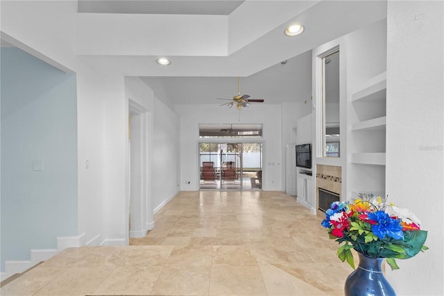 hall featuring baseboards, built in shelves, and recessed lighting