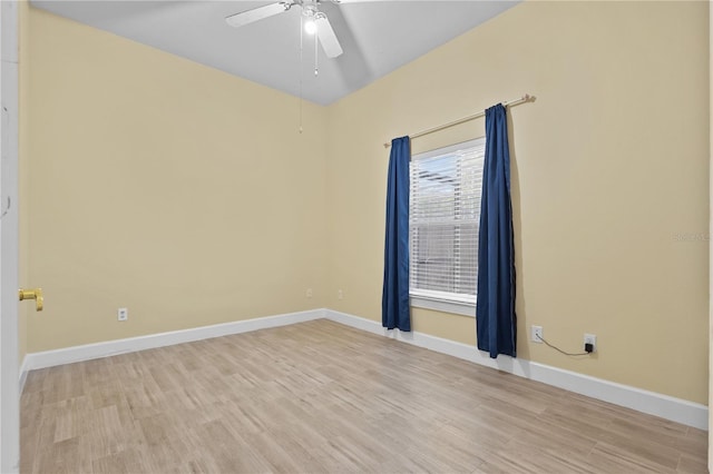 empty room featuring ceiling fan, light wood-type flooring, and baseboards