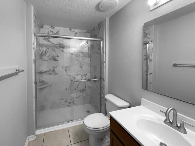 bathroom featuring toilet, vanity, a marble finish shower, and a textured ceiling