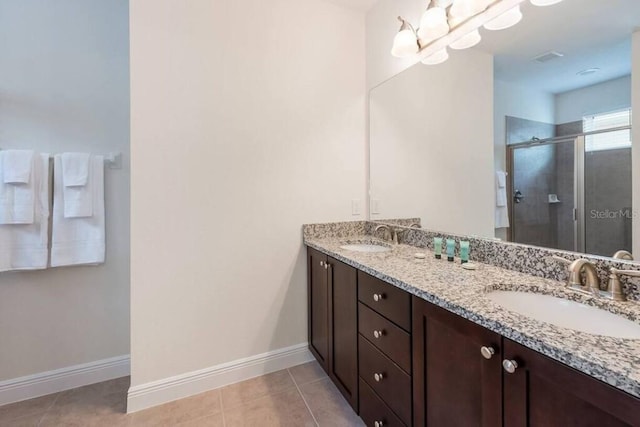 7568 Marker Ave, Kissimmee, FL 34747 - full bathroom with tile patterned flooring, a stall shower, double vanity, and a sink