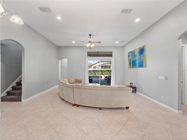 living room featuring visible vents, baseboards, ceiling fan, recessed lighting, and arched walkways