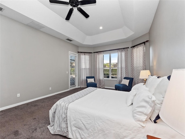 bedroom featuring carpet flooring, visible vents, a raised ceiling, and baseboards