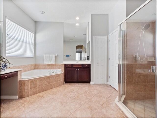 bathroom featuring recessed lighting, vanity, a garden tub, and a shower stall