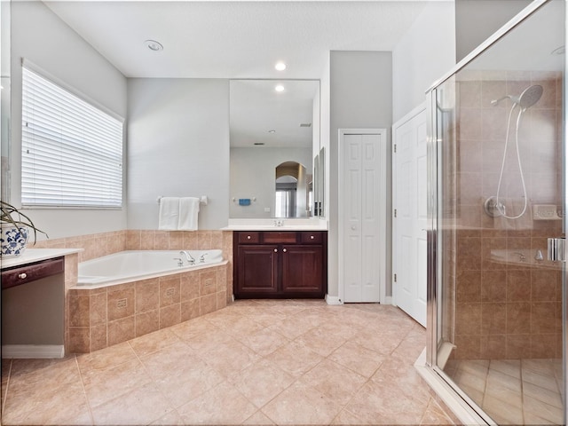 full bathroom featuring recessed lighting, a stall shower, vanity, and a garden tub