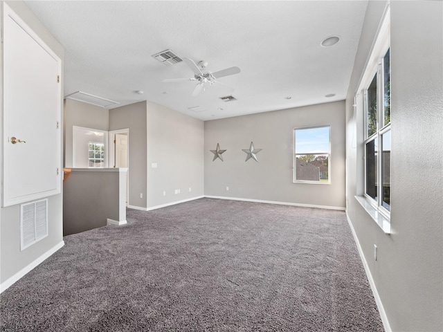 empty room with visible vents, carpet flooring, and baseboards