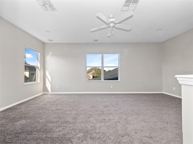 spare room featuring visible vents, carpet floors, baseboards, and a ceiling fan