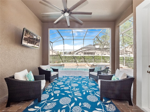 view of patio / terrace featuring a lanai, an outdoor hangout area, an outdoor pool, and ceiling fan