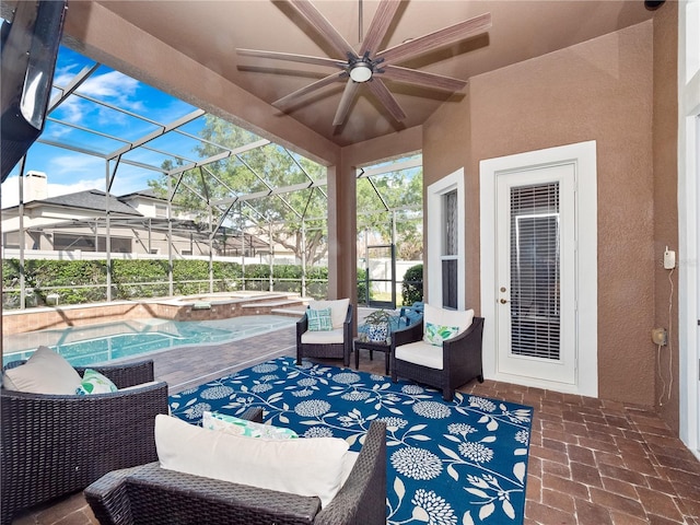 view of patio / terrace featuring an in ground hot tub, an outdoor pool, a lanai, and ceiling fan