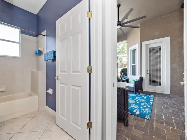 full bath featuring tile patterned floors, shower / bathing tub combination, and a ceiling fan