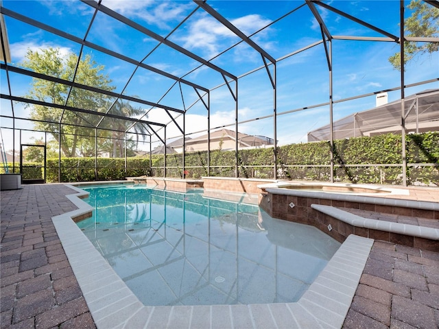 view of pool featuring a lanai, a patio area, a hot tub, and a fenced in pool