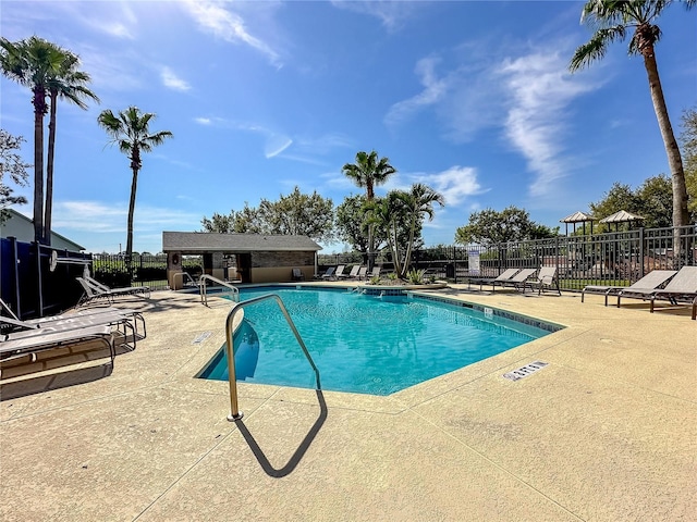 pool featuring a patio area and fence