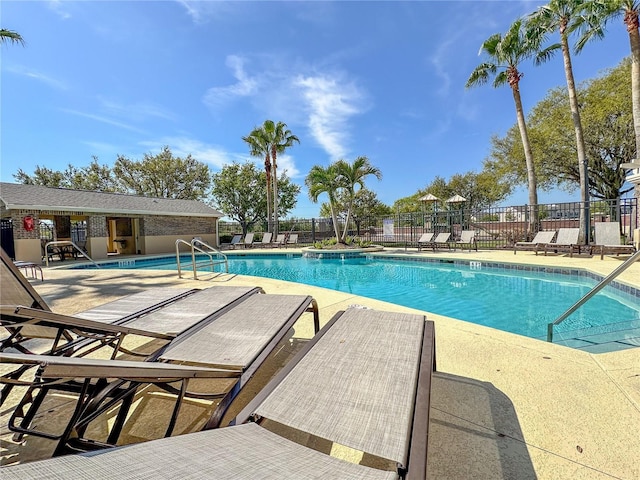 pool featuring a patio area and fence