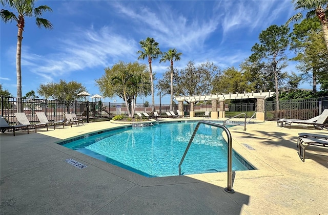 community pool featuring fence and a patio area