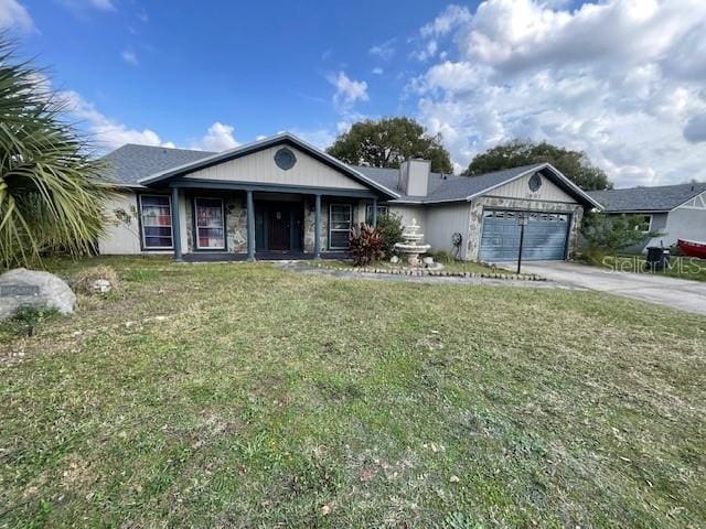 ranch-style home with driveway, an attached garage, and a front yard