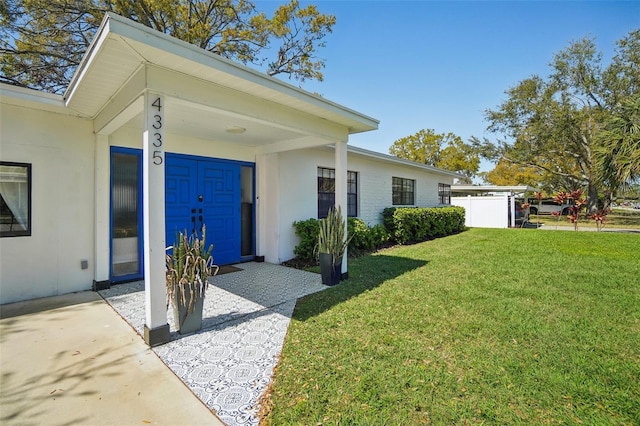 exterior space featuring a lawn and stucco siding