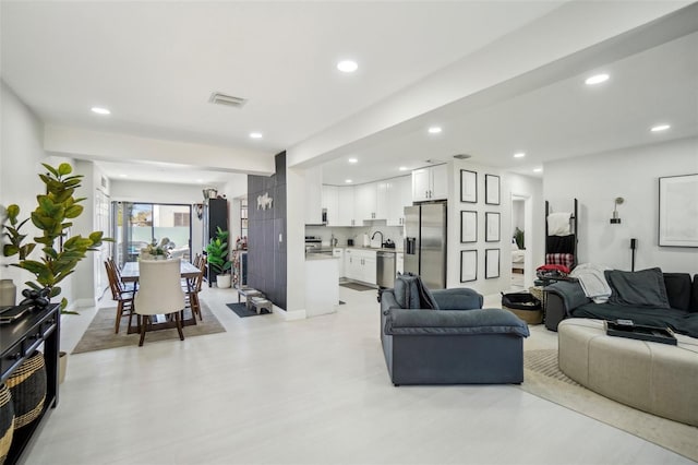 living area with recessed lighting and visible vents