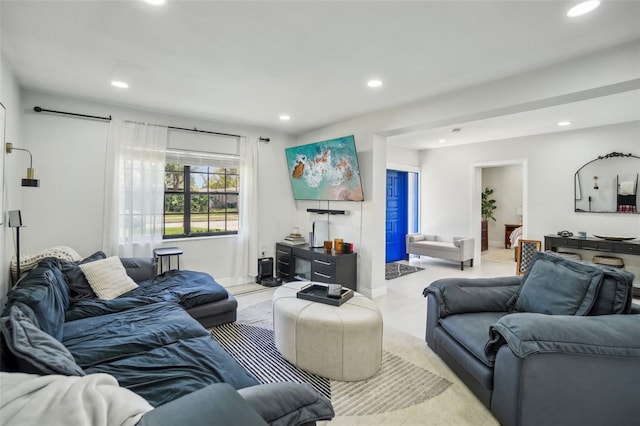 living area with baseboards and recessed lighting