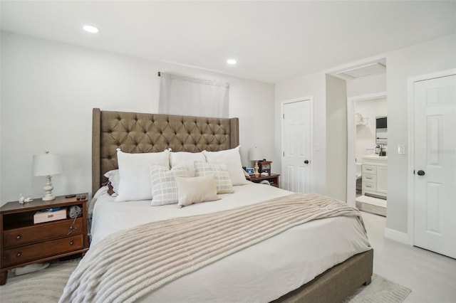 bedroom with attic access, recessed lighting, and connected bathroom